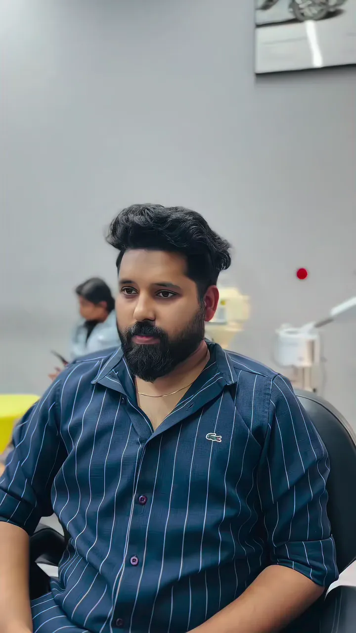 Classic swept-back haircut with a full shaped beard