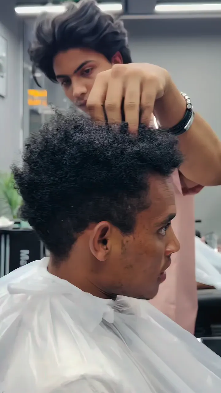 A Cloud Nine barber shaping a customer's hair in the Dubai salon