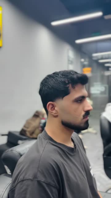 Side profile of an Italian fade with a softly styled top